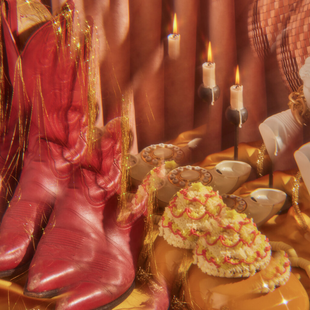 A Duplicated And Interposed Image Of Boots Candles And Other Items On A Table